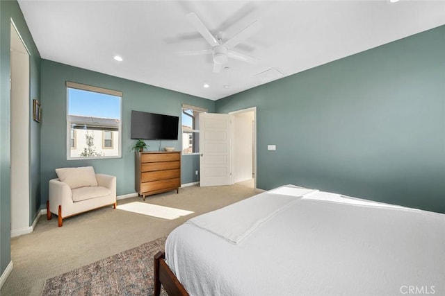 bedroom with ceiling fan and light carpet