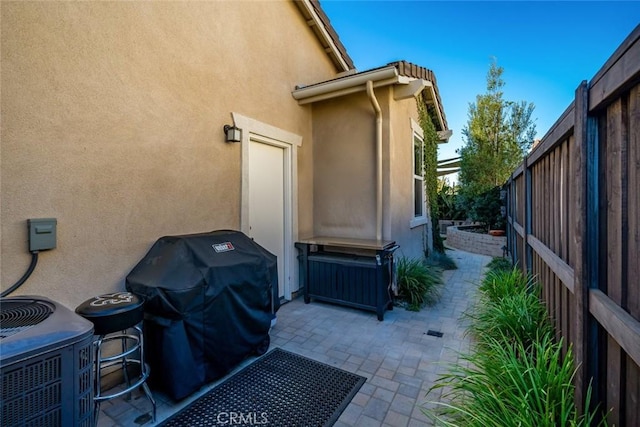 view of property exterior featuring central air condition unit and a patio