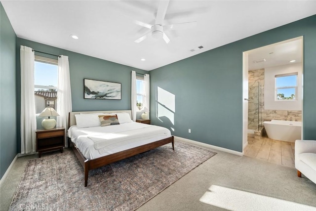 carpeted bedroom featuring ceiling fan and ensuite bath