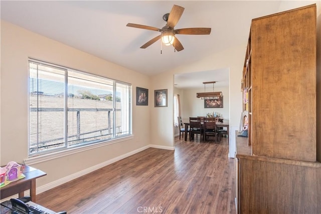 interior space with lofted ceiling, ceiling fan, and dark wood-type flooring