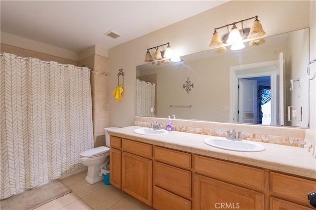 bathroom with tile patterned flooring, vanity, toilet, and a shower with shower curtain