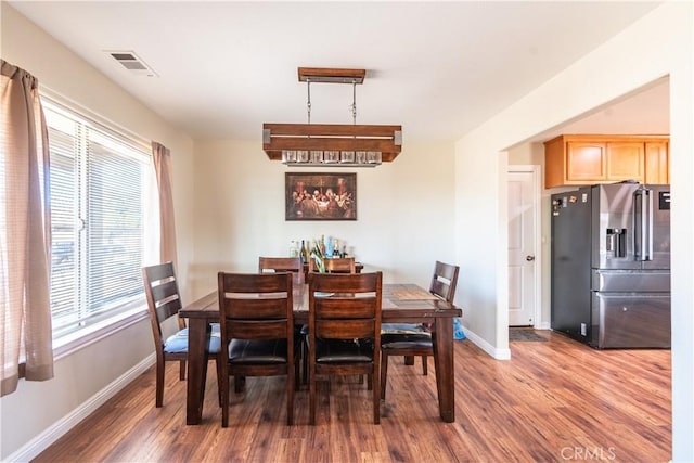 dining room featuring a wealth of natural light and dark hardwood / wood-style flooring