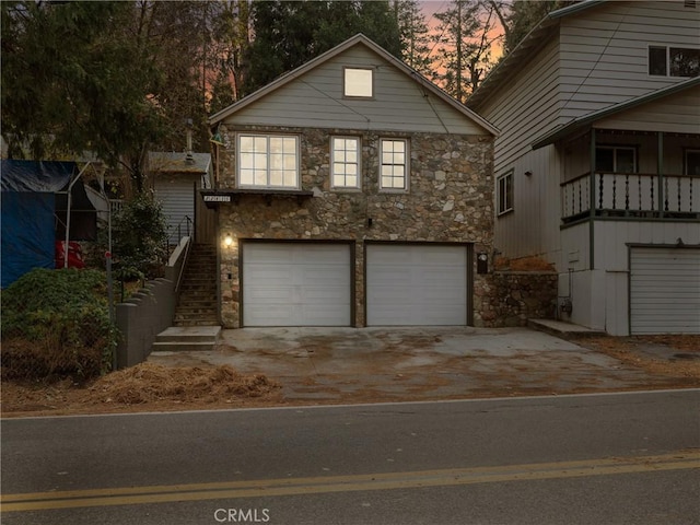 view of front of home featuring a balcony and a garage