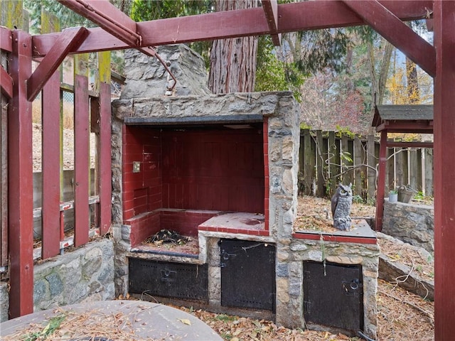 view of patio with a fireplace