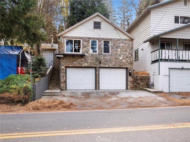 view of front of property with a balcony and a garage