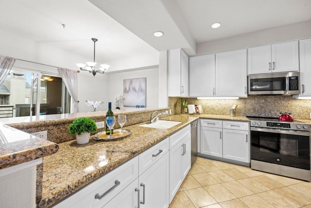 kitchen featuring an inviting chandelier, sink, appliances with stainless steel finishes, decorative light fixtures, and white cabinetry