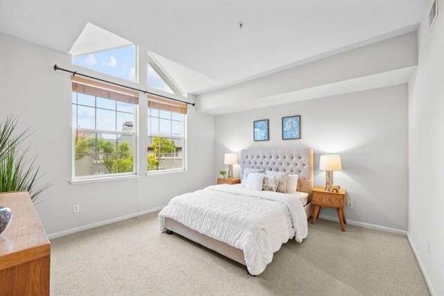 carpeted bedroom featuring vaulted ceiling