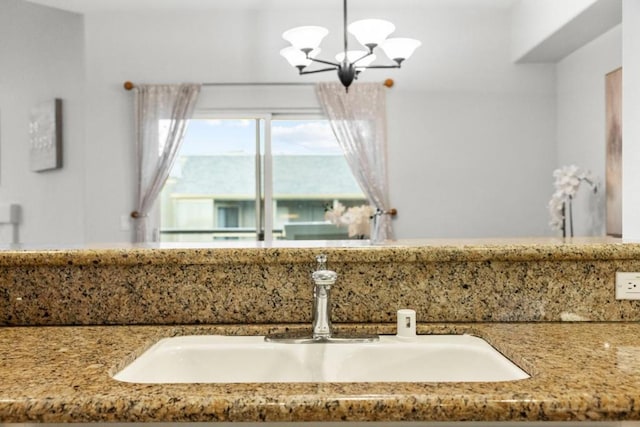 bathroom with sink and a chandelier