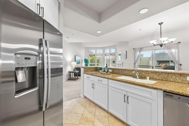 kitchen featuring white cabinets, stainless steel appliances, plenty of natural light, and sink