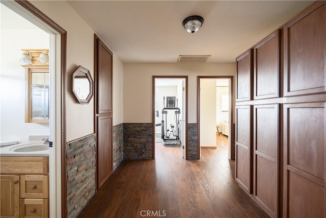 hallway featuring dark hardwood / wood-style flooring and sink