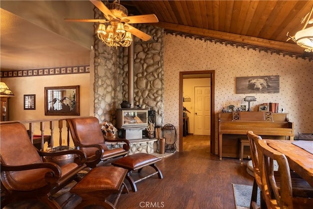 sitting room featuring wood ceiling, dark wood-type flooring, ceiling fan, vaulted ceiling, and a wood stove