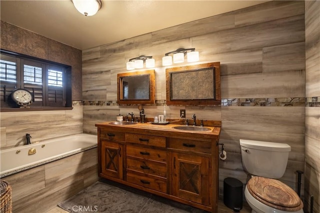 bathroom with a relaxing tiled tub, vanity, tile walls, and toilet