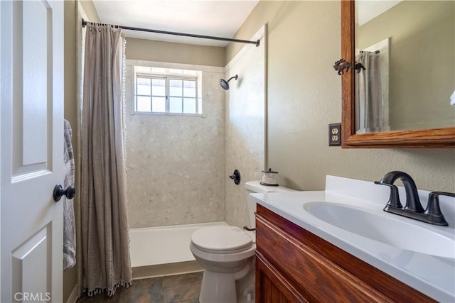 bathroom featuring walk in shower, vanity, and toilet