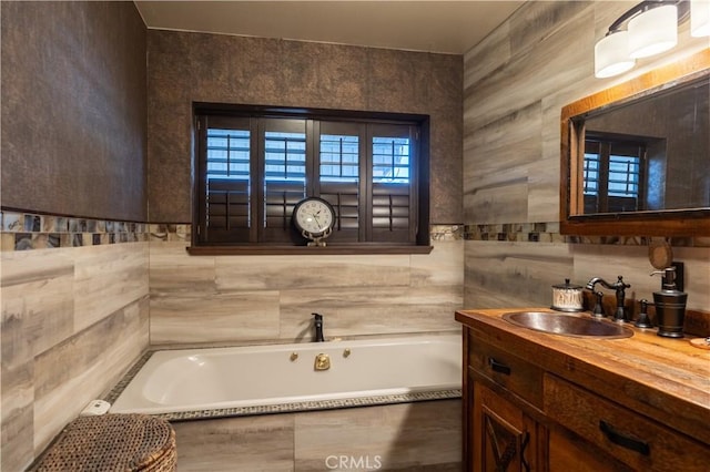 bathroom with a relaxing tiled tub and vanity