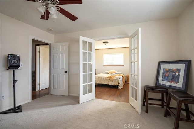 carpeted bedroom featuring french doors and ceiling fan