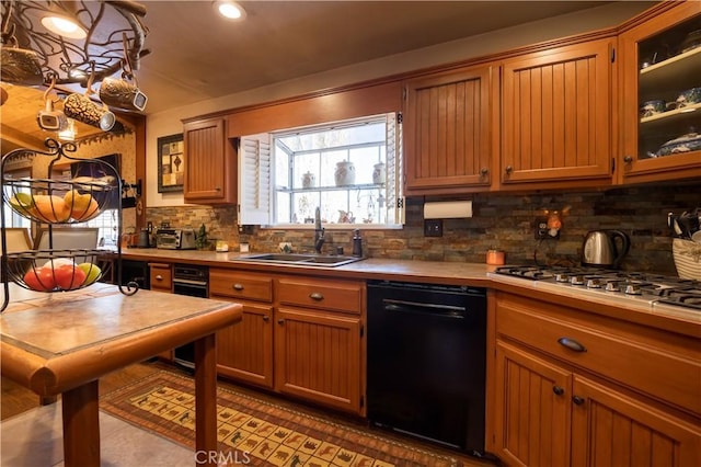 kitchen featuring tasteful backsplash, black dishwasher, sink, and stainless steel gas cooktop