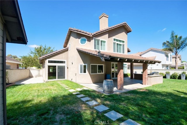 rear view of house featuring a lawn, a patio area, and area for grilling