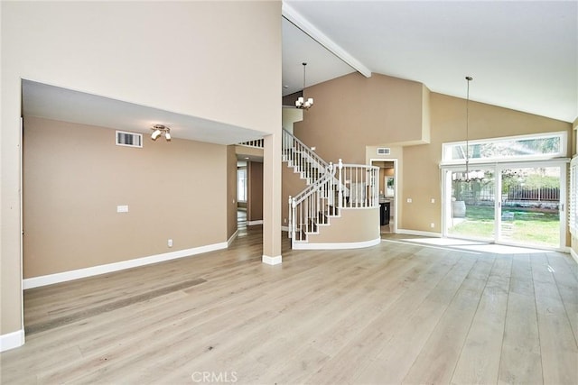 unfurnished living room featuring high vaulted ceiling, light wood-type flooring, beamed ceiling, and a chandelier