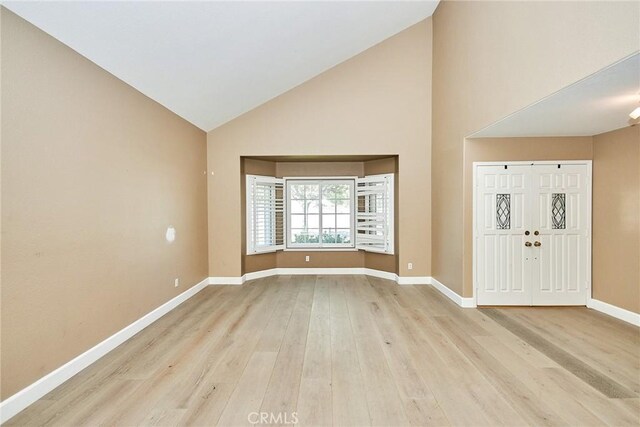 entryway featuring light hardwood / wood-style flooring and high vaulted ceiling