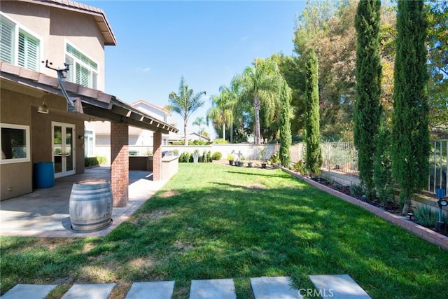 view of yard with french doors and a patio