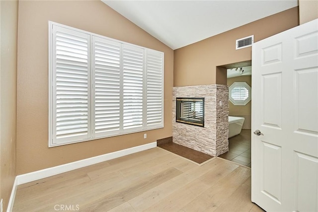 living room with lofted ceiling and light wood-type flooring