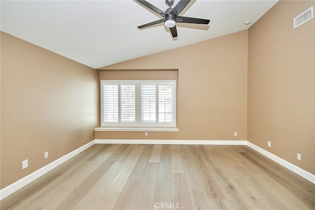 spare room featuring vaulted ceiling, ceiling fan, and light hardwood / wood-style flooring