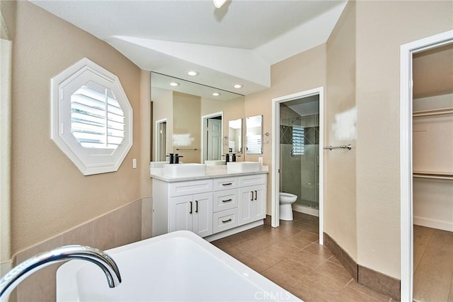 bathroom featuring an enclosed shower, lofted ceiling, tile patterned flooring, vanity, and toilet