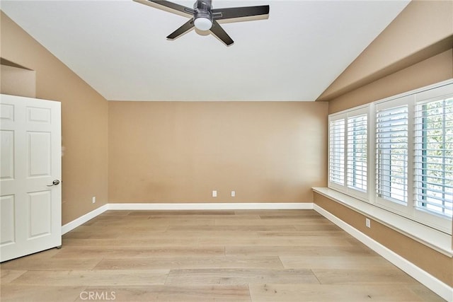 spare room with ceiling fan, light hardwood / wood-style flooring, and lofted ceiling