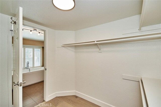 walk in closet featuring light hardwood / wood-style flooring