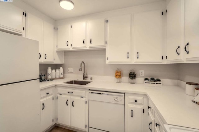 kitchen featuring white cabinets, white appliances, and sink