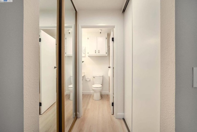 hallway with light hardwood / wood-style flooring