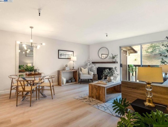 living room featuring an inviting chandelier and light hardwood / wood-style flooring