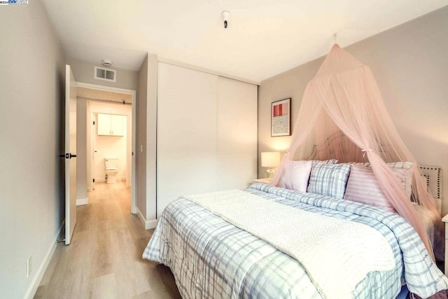 bedroom featuring light hardwood / wood-style floors and a closet