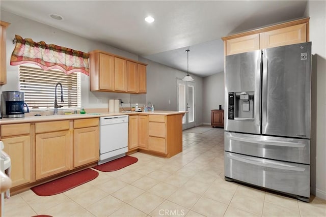 kitchen with a sink, light countertops, stainless steel fridge with ice dispenser, dishwasher, and light brown cabinetry