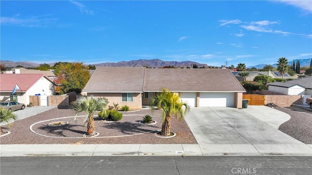 ranch-style house with a mountain view and a garage