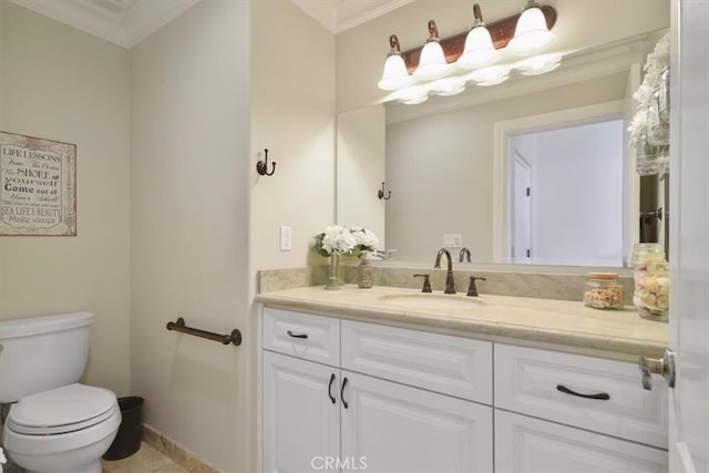 bathroom with vanity, crown molding, and toilet