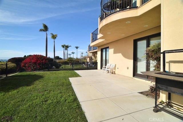 view of yard featuring a patio and a balcony