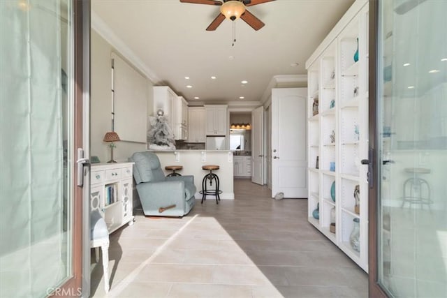 interior space featuring crown molding and ceiling fan