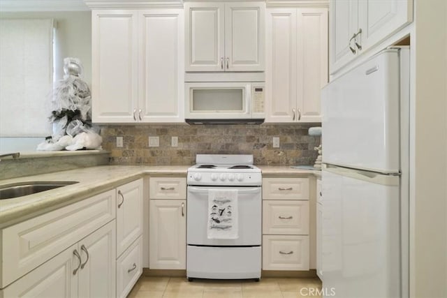 kitchen featuring sink, light tile patterned floors, white appliances, and decorative backsplash