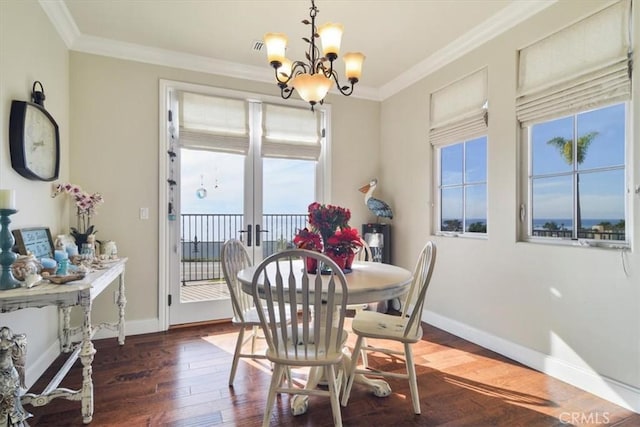 dining space with an inviting chandelier, ornamental molding, and dark hardwood / wood-style floors