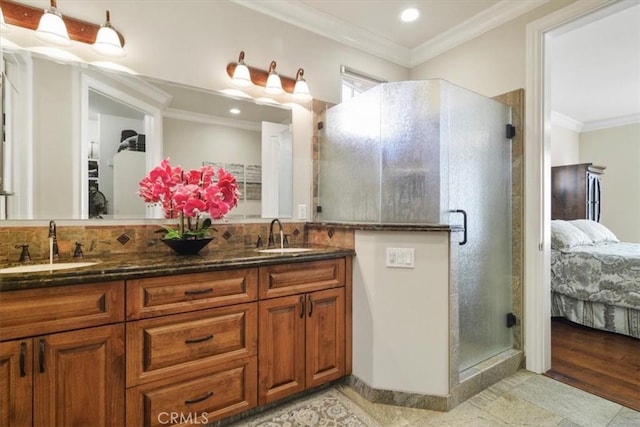 bathroom featuring vanity, crown molding, and a shower with door