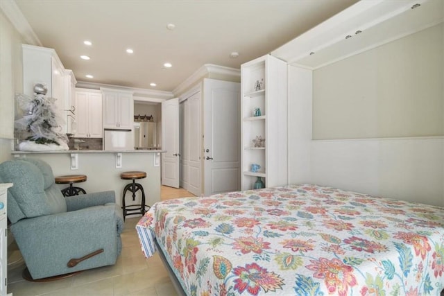 bedroom with crown molding and refrigerator