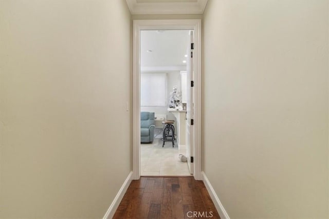 hall with crown molding and hardwood / wood-style flooring