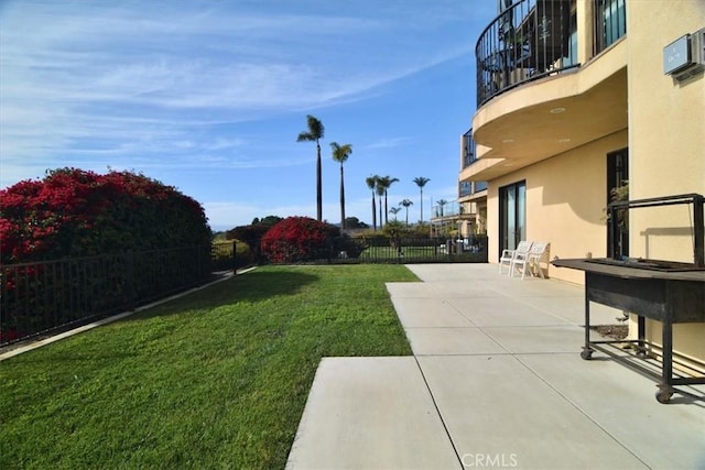 view of yard featuring a balcony and a patio area