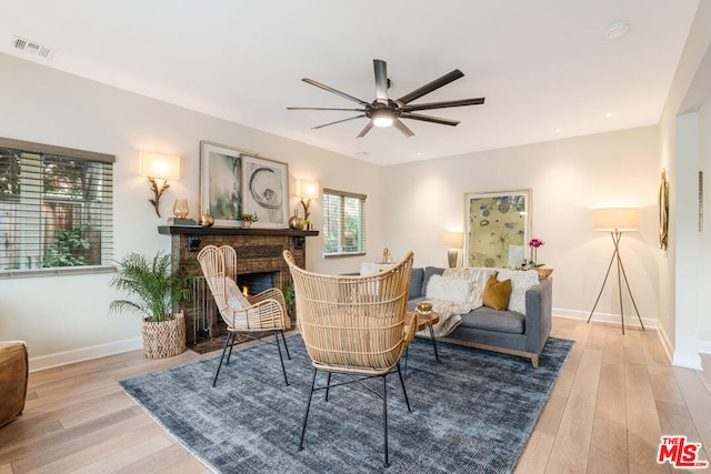 sitting room featuring ceiling fan and light hardwood / wood-style flooring