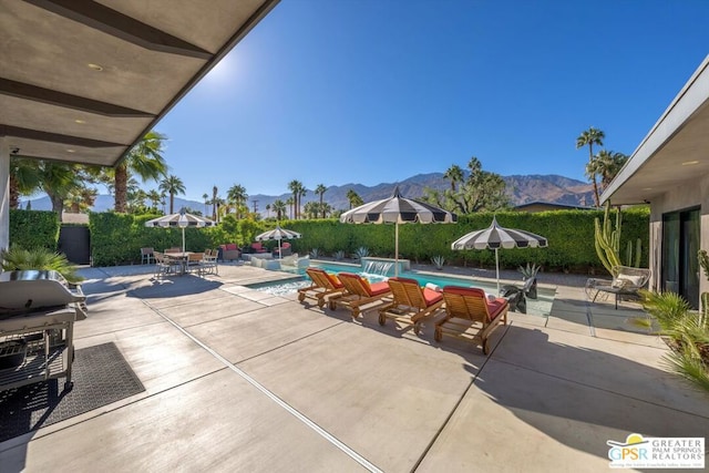 exterior space featuring a mountain view and a fenced in pool