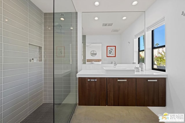 bathroom featuring vanity and tiled shower