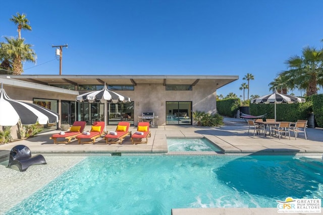 view of pool featuring a patio area and a grill