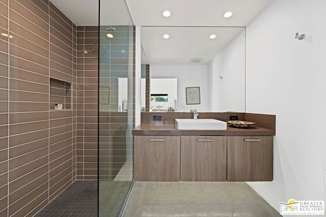 bathroom featuring vanity and a tile shower