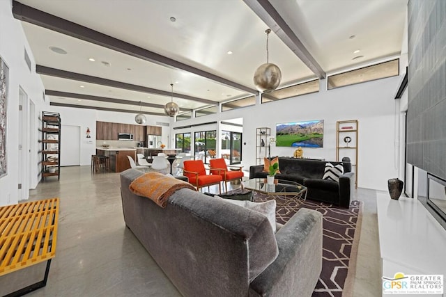 living room with beamed ceiling and concrete flooring